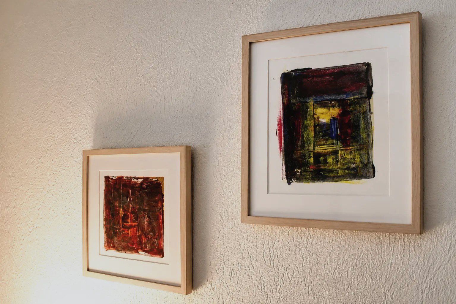 Two framed artworks on the wall of the Malo studio